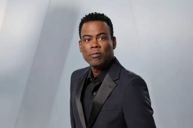 Chris Rock in a black suit