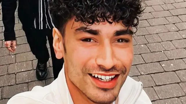 Matt Woolford smiles upwards at the camera