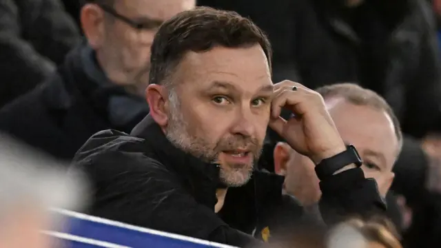 Derby boss John Eustace watches from the stands at Fratton Park
