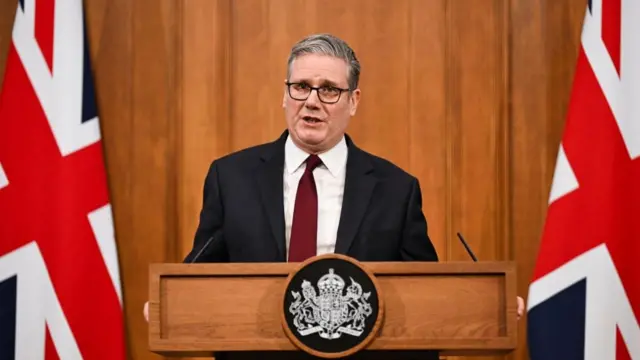 Keir Starmer standing behind podium.