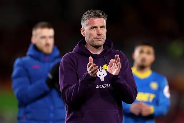 Rob Edwards, Manager of Wolverhampton Wanderers, applauds the fans