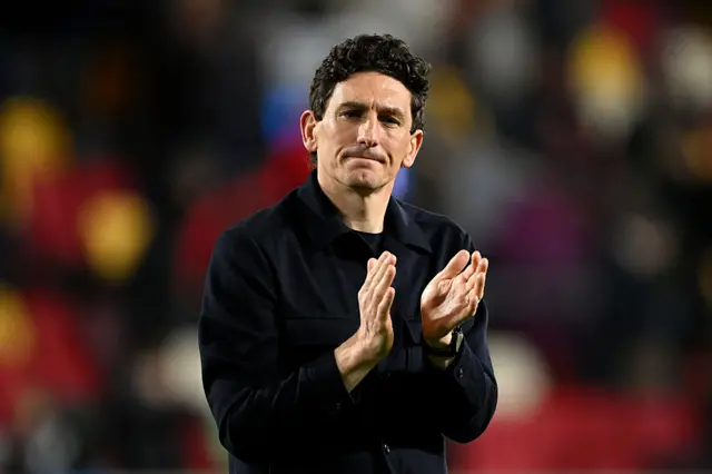 Keith Andrews, Manager of Brentford, applauds the fans