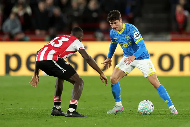 Hugo Bueno of Wolverhampton Wanderers is challenged by Michael Kayode of Brentford