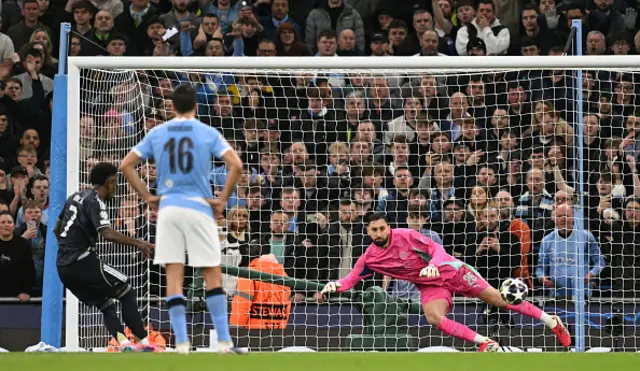 Gianluigi Donnarumma (R)dives the wrong way as he fails to save a penalty by Real Madrid's Brazilian forward #07 Vinicius Junior