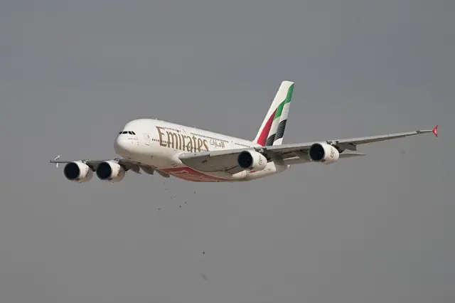 An Emirates airline plane mid-air
