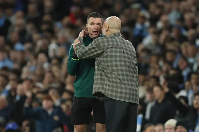 Pep Guardiola, Manager of Manchester City speaks to Fourth Official Willy Delajod