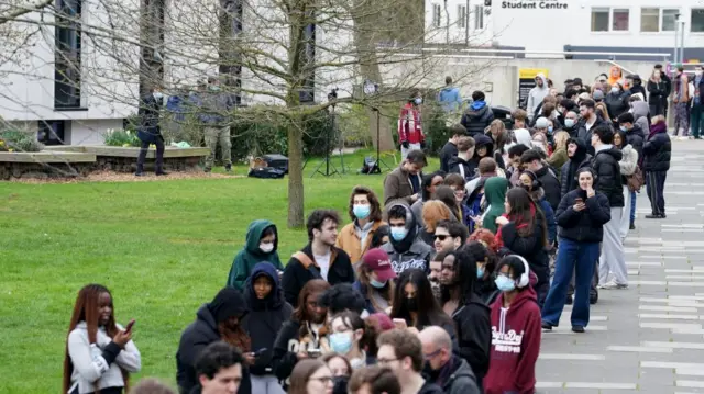 Students queuing for antibiotics outside a building at the University of Kent in Canterbury