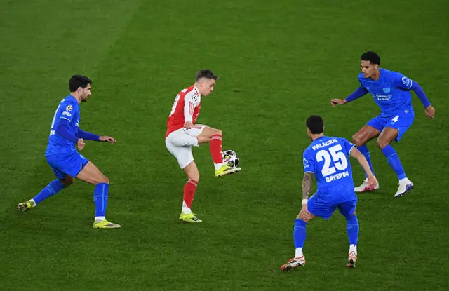 Leandro Trossard of Arsenal controls the ball under pressure from Martin Terrier, Exequiel Palacios and Jarell Quansah