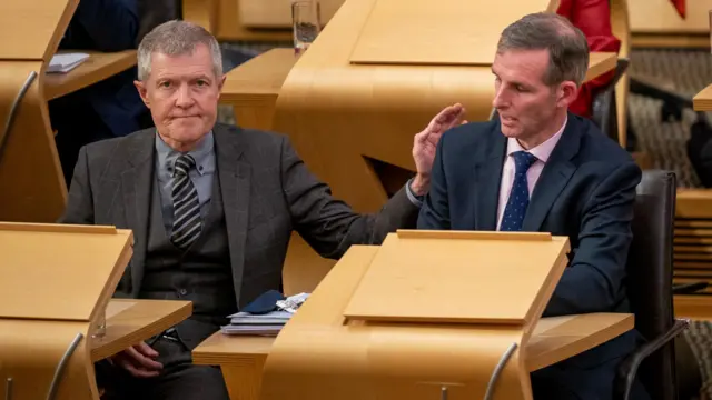 Willie Rennie pats Liam McArthur on the shoulder
