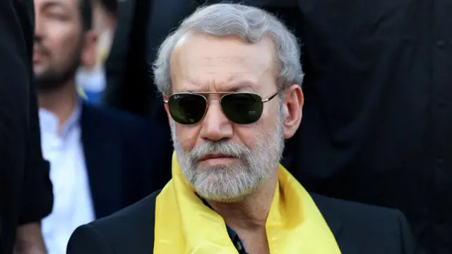 Ali Larijani in a yellow scarf and sunglasses