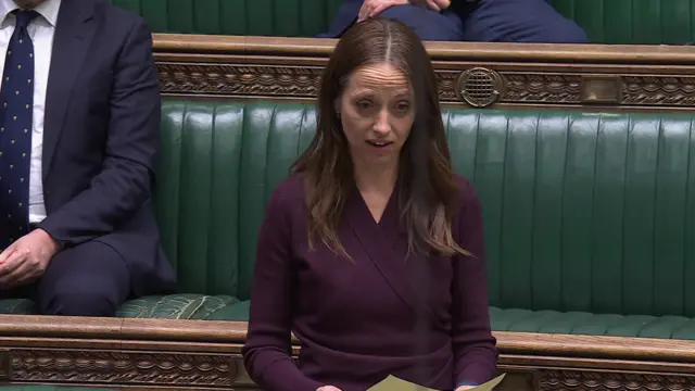 MP Helen Whately speaking from a sheet of paper and looking up in the House of Commons green benches