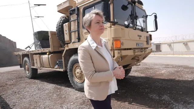 Yvette Cooper in front of truck