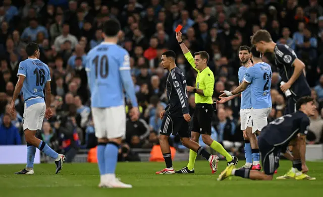 French referee Clément Turpin shows a red card to Manchester City's Portuguese midfielder #20 Bernardo Silva