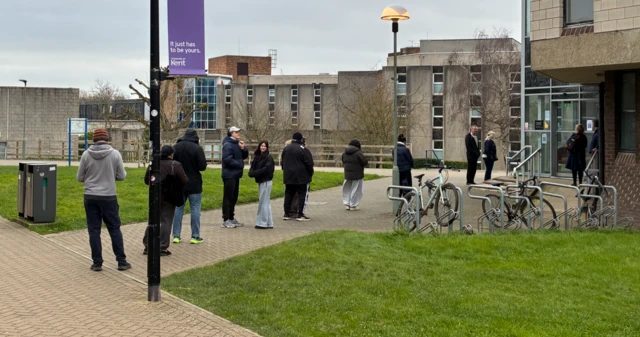 People queue outside a clinic