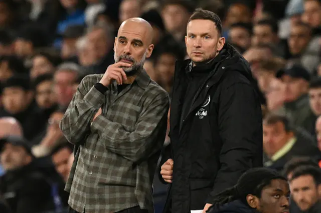 Pep Guardiola (L) chats with Manchester City's Dutch assistant coach Pepijn Lijnders