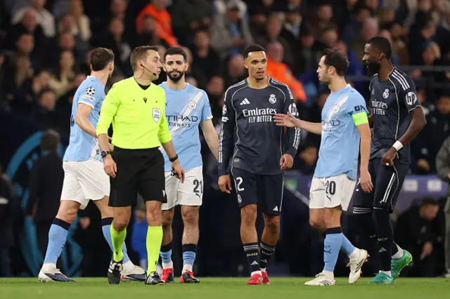 Trent Alexander-Arnold of Real Madrid looks on as Bernardo Silva of Manchester City interacts with Referee Clement Turpin