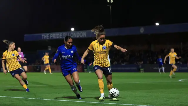 Marisa Olislagers of Brighton & Hove Albion is challenged by Alyssa Thompson of Chelsea