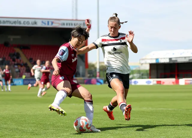 Ueki tries to dribble past Le Tissier