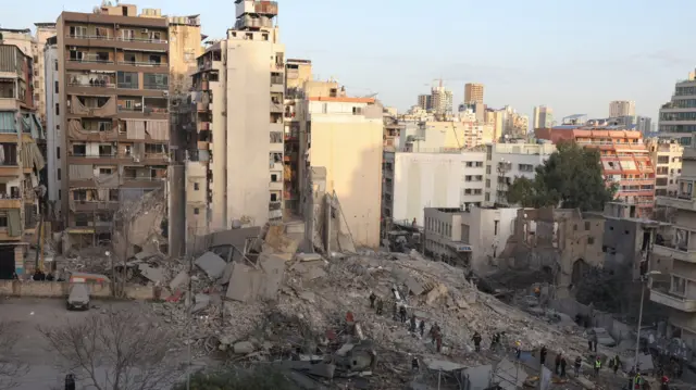 Emergency personnel work at the site of a collapsed building, in the aftermath of an Israeli strike, following an escalation between Hezbollah and Israel amid the U.S.-Israeli conflict with Iran, in central Beirut's Bachoura neighbourhood, Lebanon, March 18,