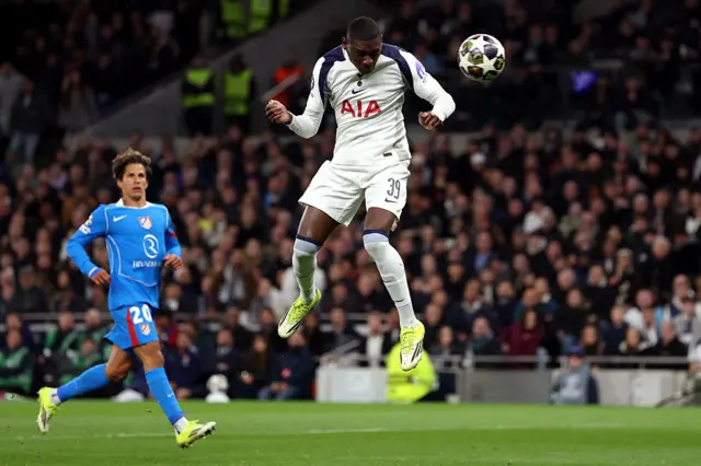 Randal Kolo-Muani heads the ball for Tottenham