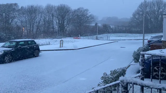 Snow on the ground of a residential street in Devon.
