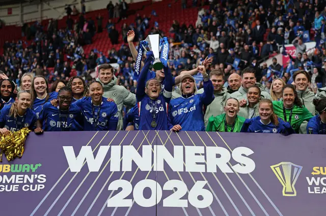 Cuthbert lifts the League Cup trophy alongside her team-mates