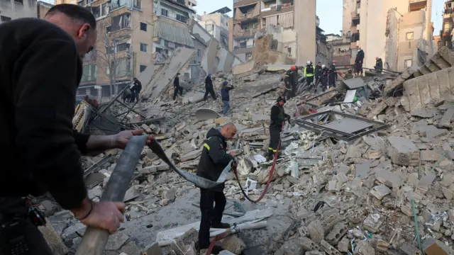 Emergency personnel work at the site of a collapsed building in central Beirut's Bachoura neighbourhood