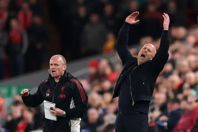 Arne Slot, Manager of Liverpool, and Sipke Hulshoff, Assistant Coach of Liverpool, react