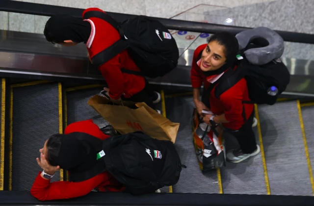 Members of the Iranian women's soccer team head to the immigration counters inside Kuala Lumpur International Airport in Sepang, Malaysia