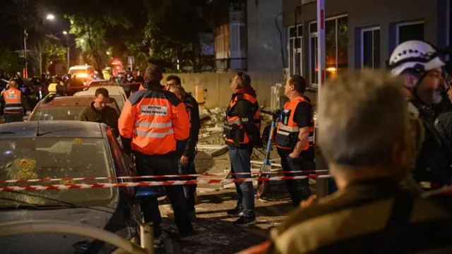 Emergency workers respond to a missile attack in the Tel Aviv suburb of Ramat Gan, Israel