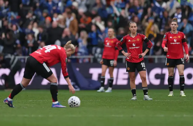 Manchester United players look despondent as they prepare to kick off after conceding