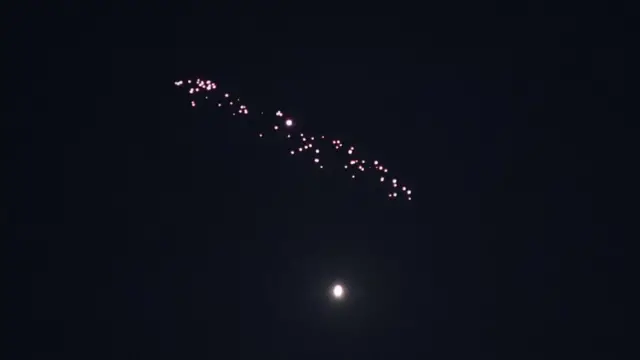 Missiles launched from Iran streak across the sky over Tel Aviv