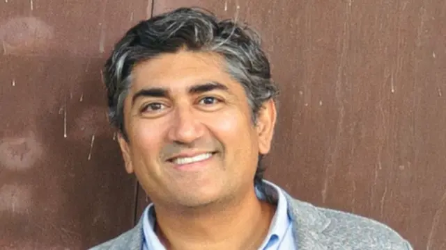 Aneesh Raman in a shirt and blazer.