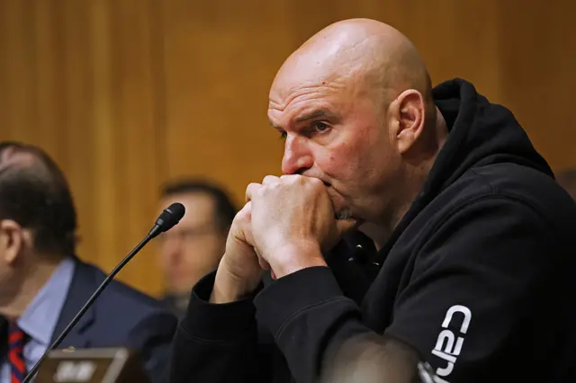 Fetterman crosses his hands in front of his face