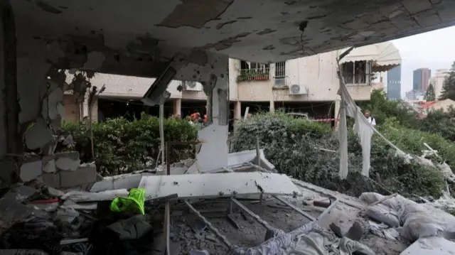 A damaged building at an impact site, following a barrage of missiles launched from Iran, amid the U.S.-Israeli conflict with Iran, in Ramat Gan, Israel, March 18, 2026