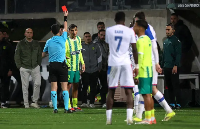 Petros Ioannou of AEK Larnaca is shown a red card