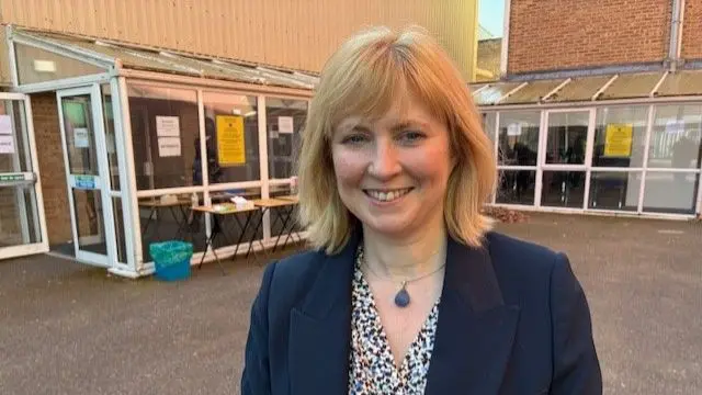 Canterbury MP Rosie Duffield stands in front of a glass conservatory