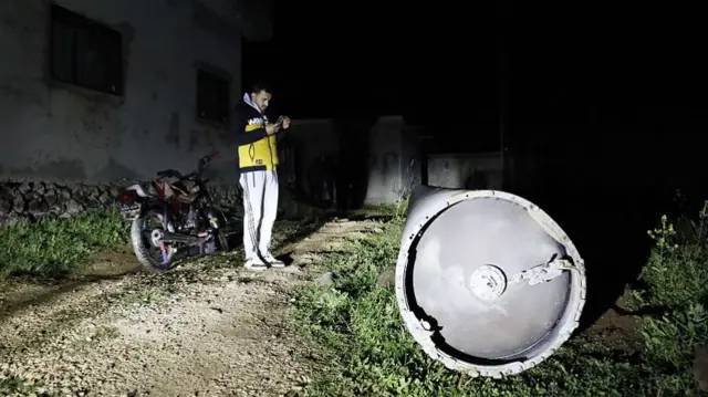 A general view of the Iranian missile that fell in the village of Ayn Farha after being destroyed by air defense systems in the Quneitra province of southern Syria.