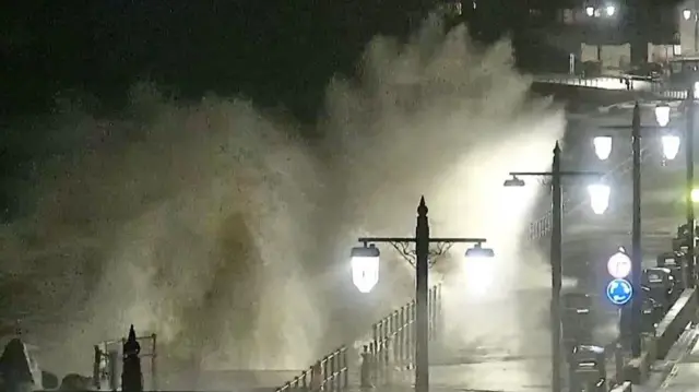A wave crashes into the esplanade in Sidmouth