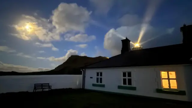 The sun peers through a cloudy sky in Mortehoe.