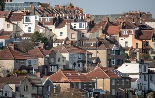Wide shot of a residential area of Bristol, several homes with red tile roofing in the foreground