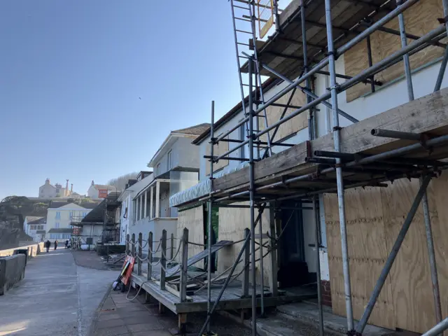 Scaffolding on buildings along the seafront in Torcross.