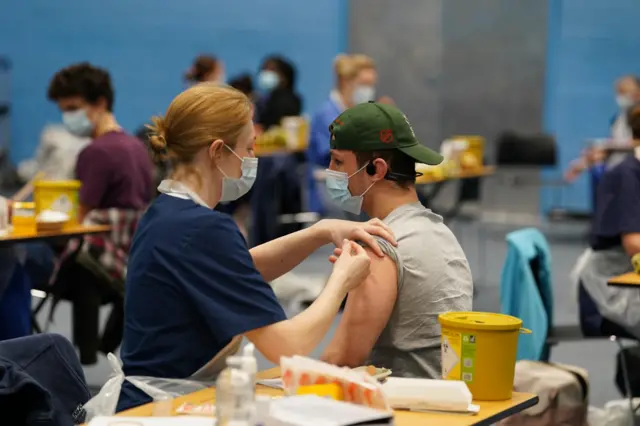 A student receiving an injection in the sports hall at the University of Kent campus in Canterbury