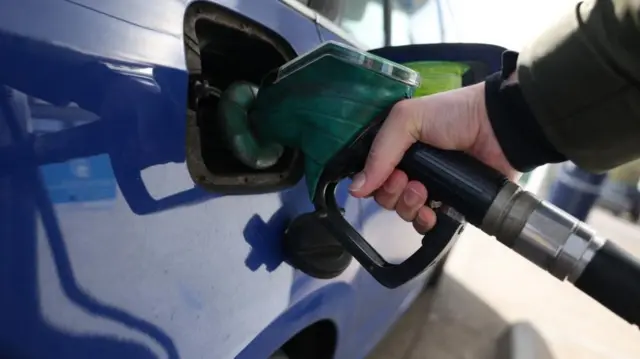 A person refuels a car at a petrol forecourt in London, Britain, 10 March 2026. Global oil prices have risen sharply after Iran's response to US and Israeli airstrikes disrupted shipping.