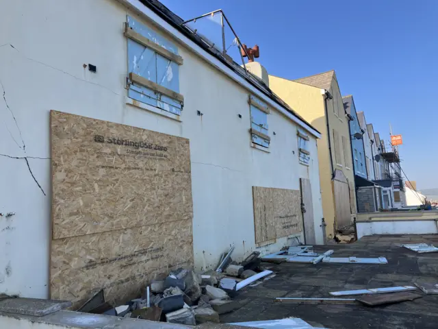 Boarded up buildings in Torcross.