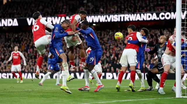 Jurrien Timber of Arsenal scores his team's second goal past Robert Sanchez of Chelsea