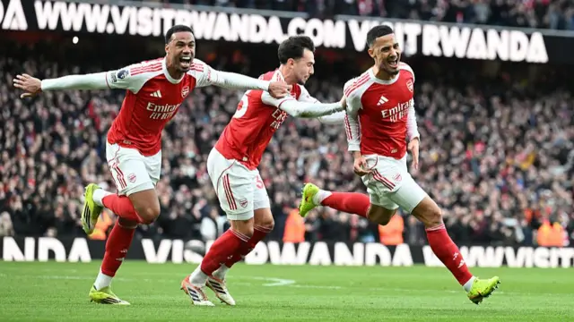 William Saliba of Arsenal celebrates scoring his team's first goal with Gabriel and Martin Zubimendi