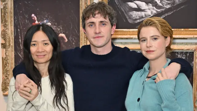 Chloé Zhao, Paul Mescal and Jessie Buckley attend a photocall for new exhibition Hamnet: Even As A Shadow, Even As A Dream at Tristan Hoare Gallery in London last year; they are in casual clothes