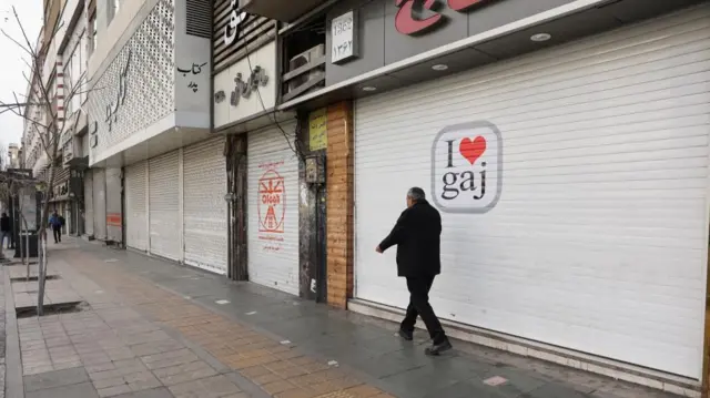 A man walks near closed shops following the killing of Iran's late Supreme Leader Ayatollah Ali Khamenei in Israeli and U.S. strikes on Saturday, in Tehran, Iran, March 2, 2026.
