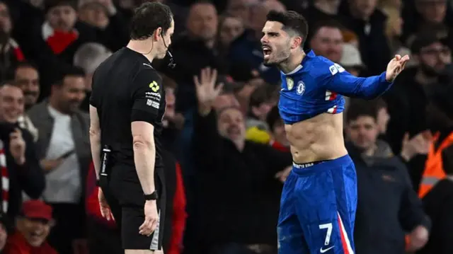 Pedro Neto of Chelsea reacts towards Referee Darren England after showing him a red card